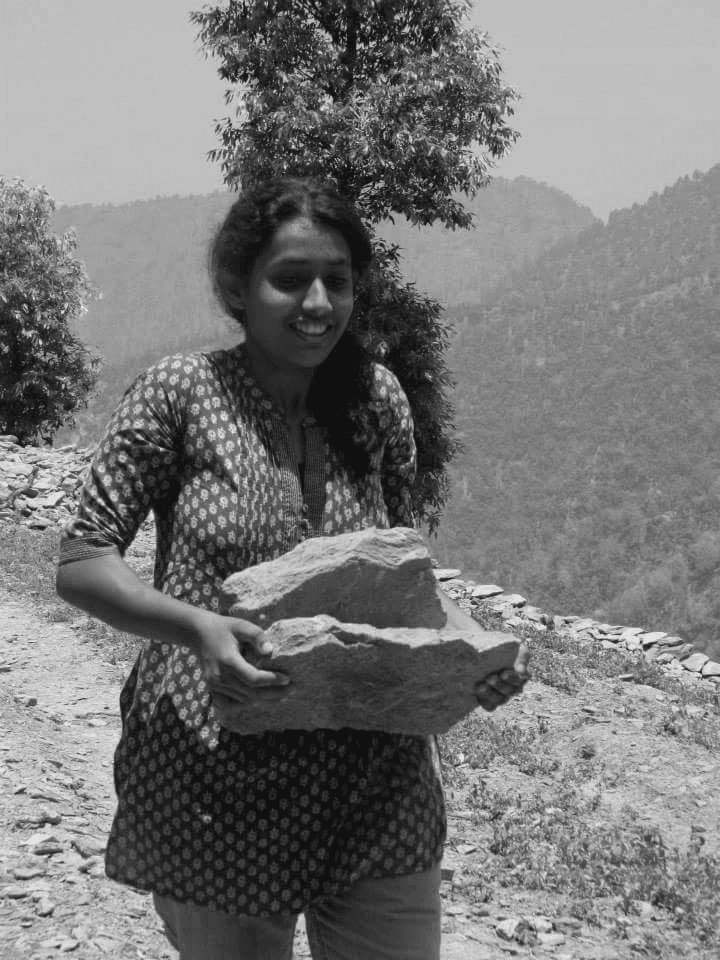 Chandra holding a stone outdoors